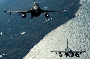 Polish Air Force F-16 and a Hungarian Air Force Gripen fly in formation during a training sortie over Greece