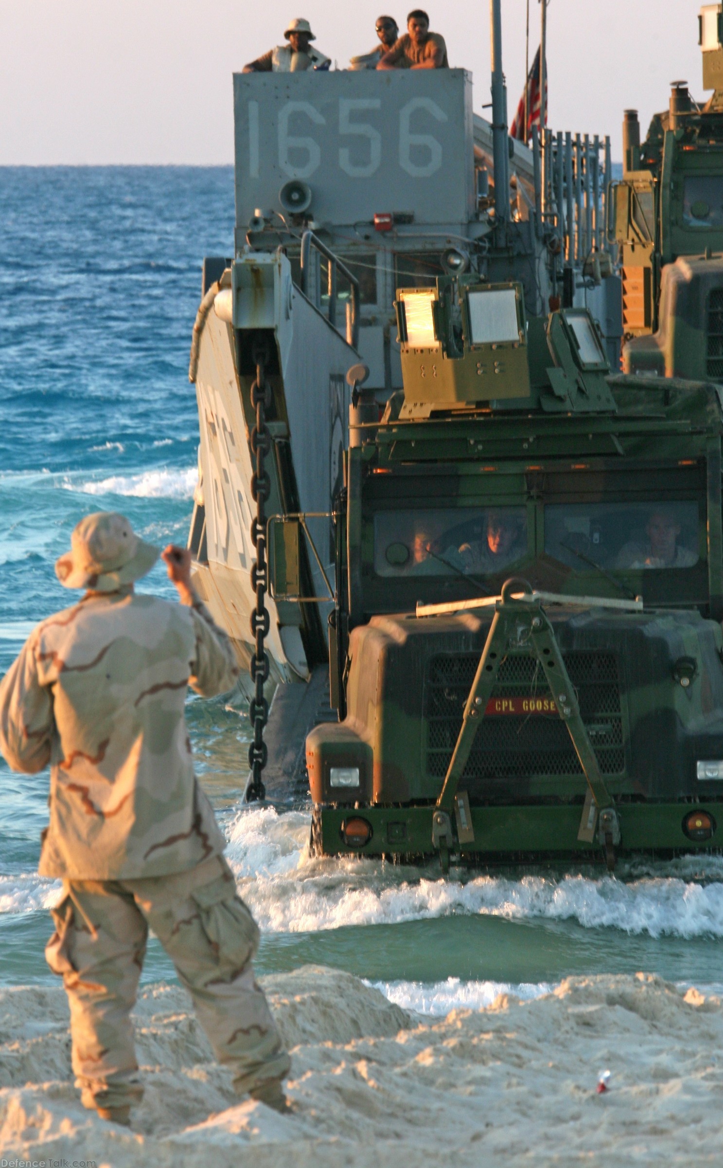 A naval beach master guides a 7-ton truck