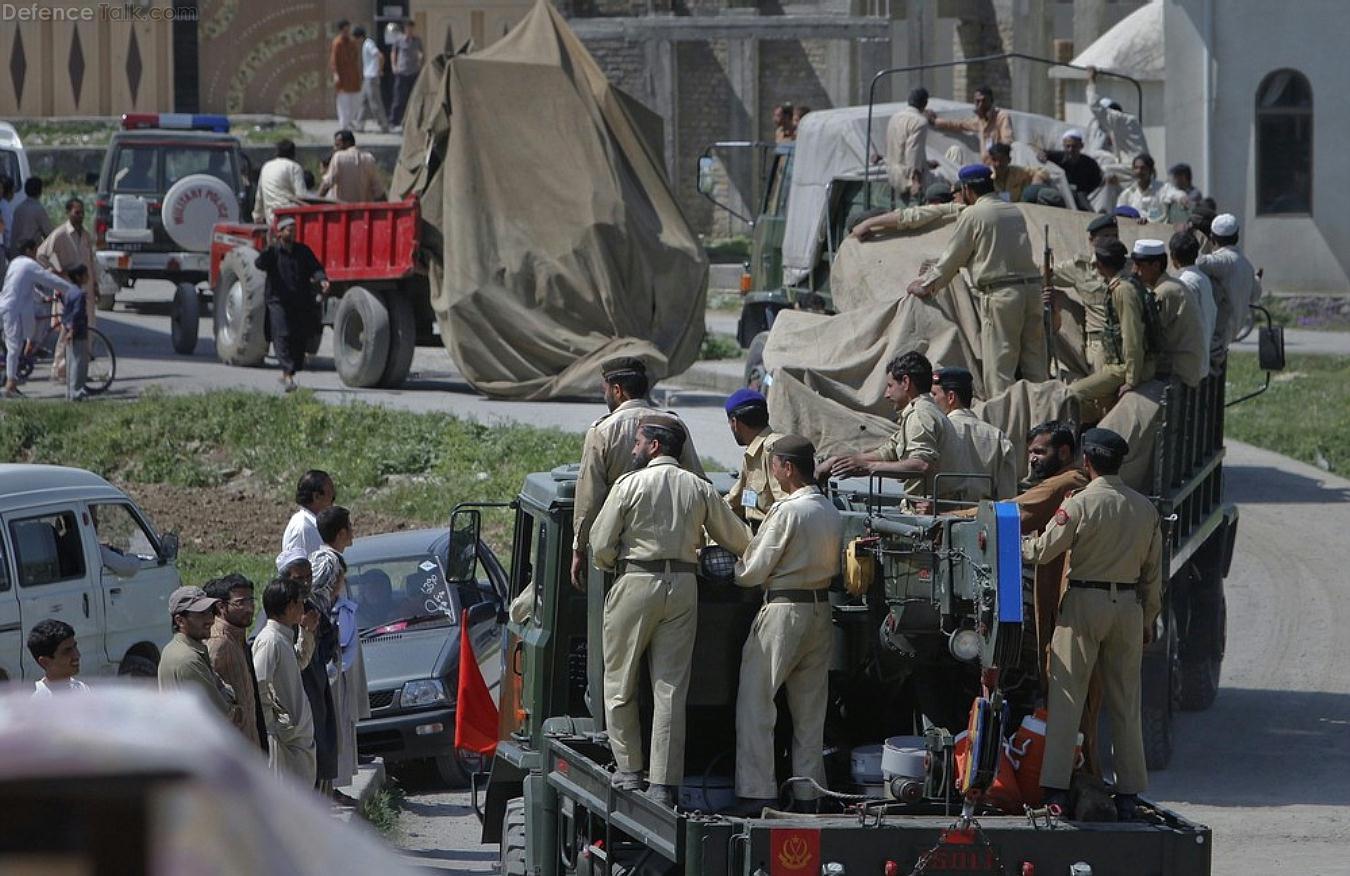 Pakistani soldiers remove the wreckage of a helicopter