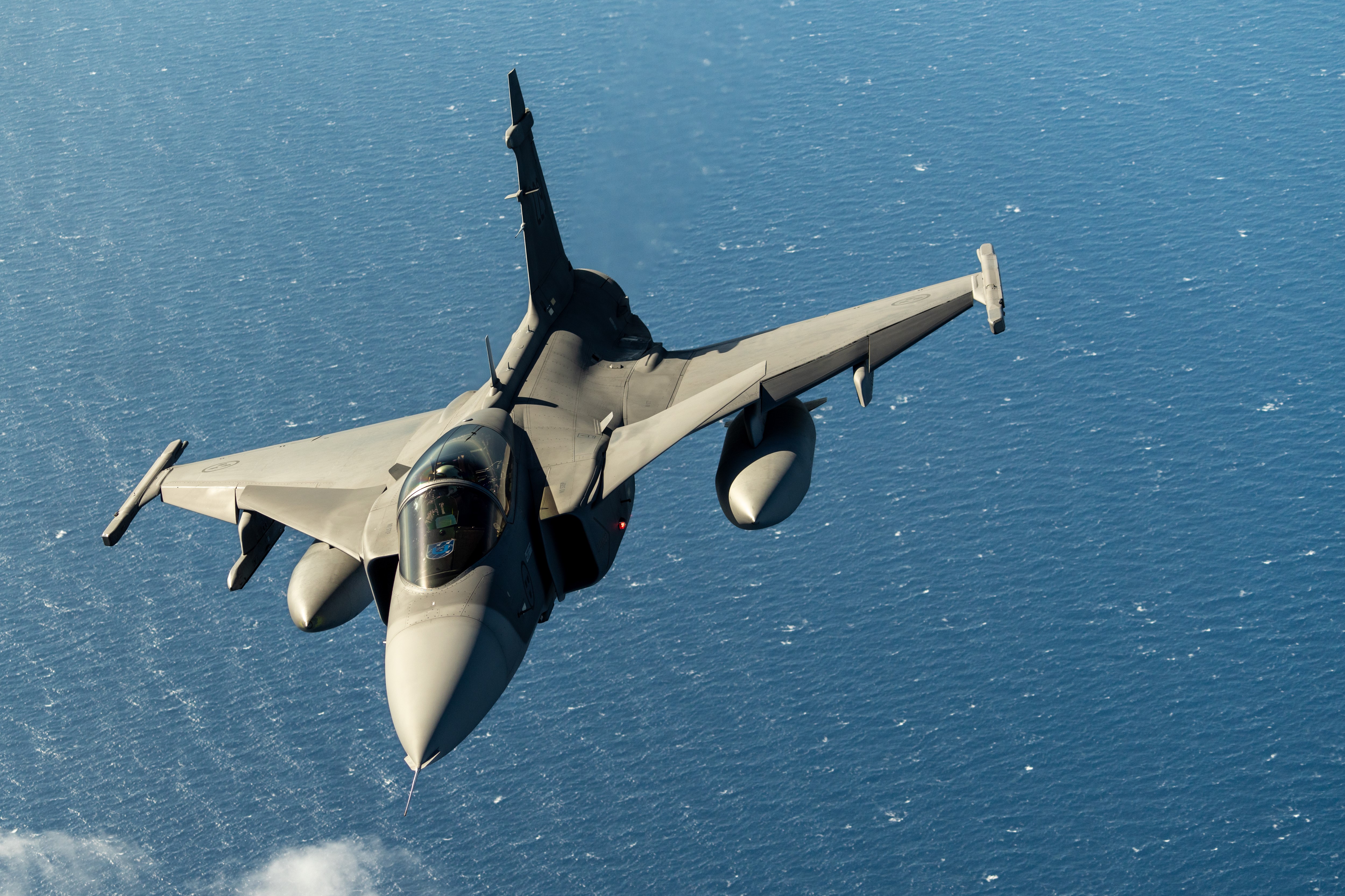 Swedish Air Force Gripen flies over Greece during a training sortie