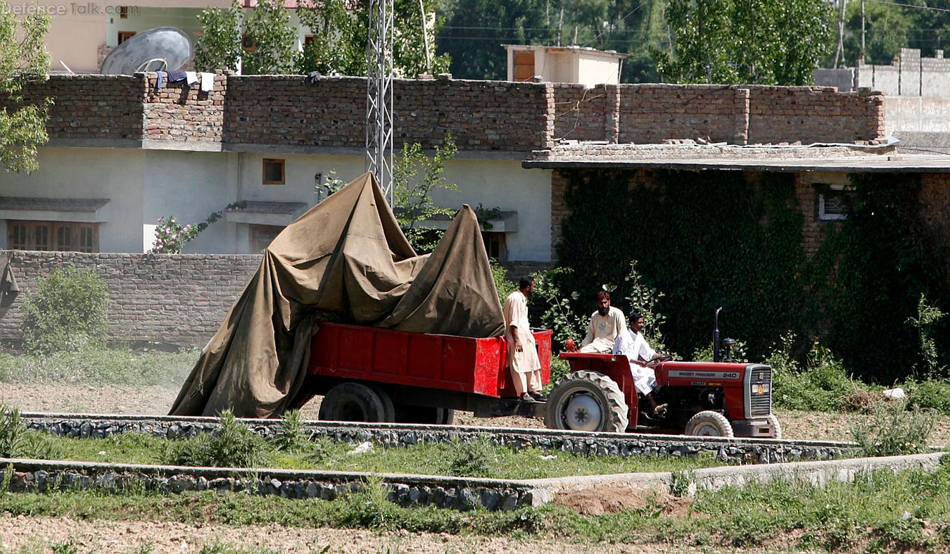 Tractor trolley carries the wreckage of a helicopter